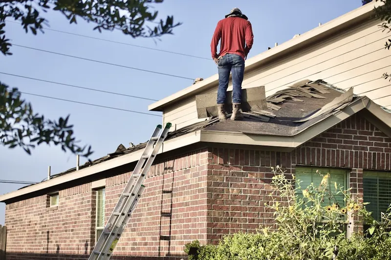 Professional roofer working on a residential roof in Towners